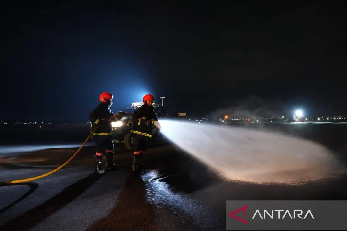 Petugas bandara membersihkan landasan pacu atau runway dari paparan abu vulkanik dampak erupsi Gunung Anak Krakatau.